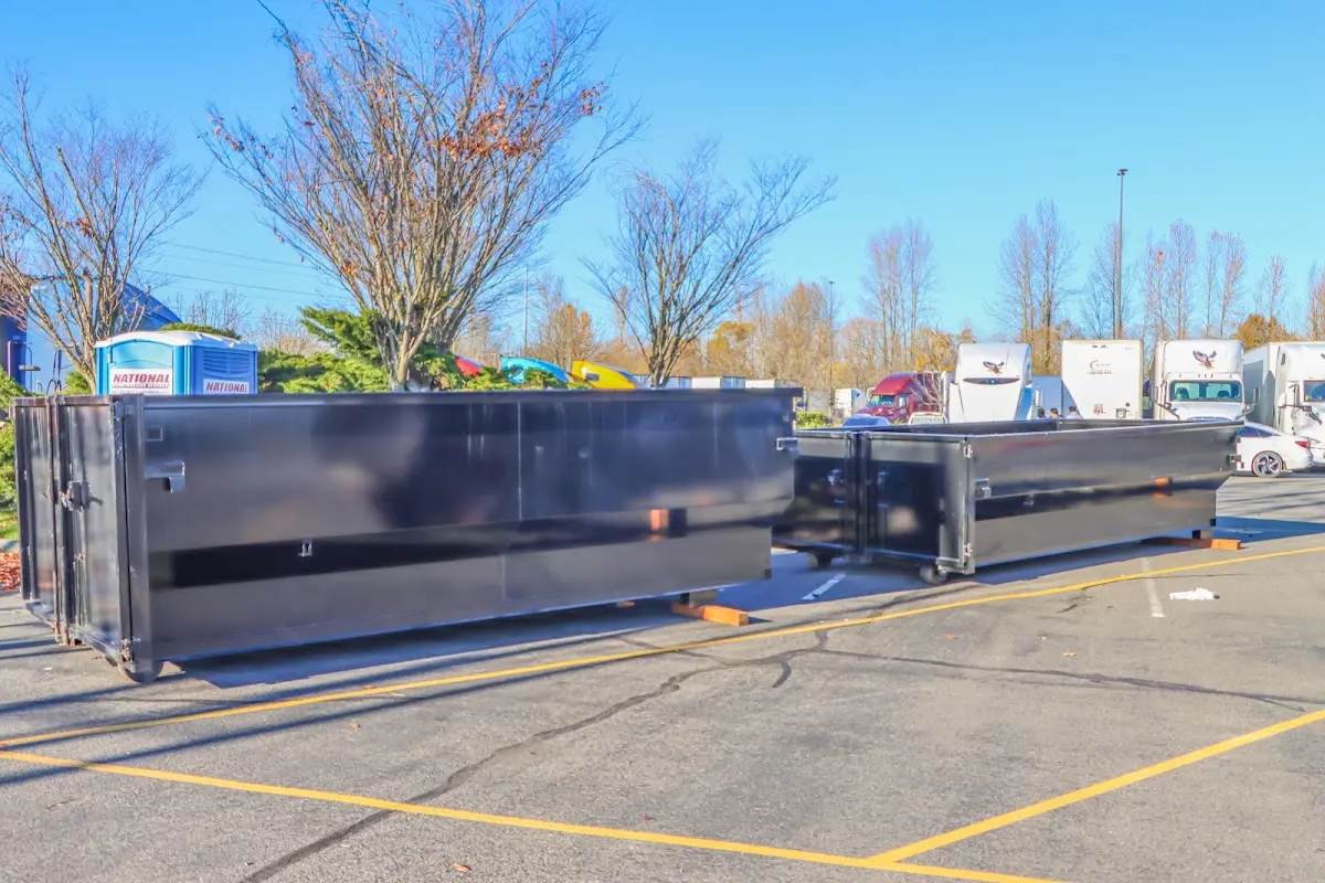 Professional dumpster rental service with roll-off container on residential driveway in Borger